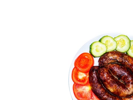 Smoked meat sausage on a plate with tomatoes and cucumbers on a white background. Smoked sausage. Pork meat. Chopped vegetables. Red tomato. Green cucumber. White background. Home kitchen.