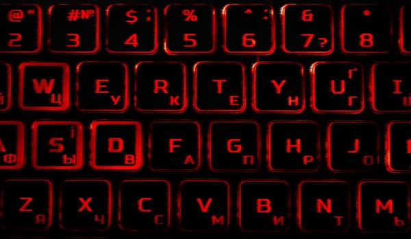 Computer keyboard in black and red colors abstract illustration. Computer techologies. Typing on the keyboard. Abstract background image. Red illumination of laptop buttons.