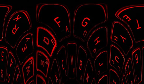 Computer keyboard in black and red colors abstract illustration. Computer techologies. Typing on the keyboard. Abstract background image. Red illumination of laptop buttons.