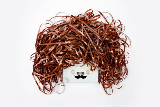 Conceptual face with audio tape over bright background