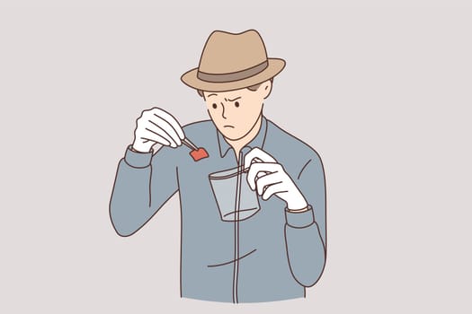 Detective with evidence working concept. Young serious an working as detective in hat putting piece of paper evidence of crime to special transparent bag