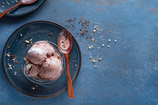 Homemade Organic chocolate Ice Cream scoops with nuts in a bowl