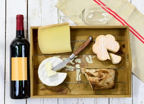 tray different french cheeses with red wine