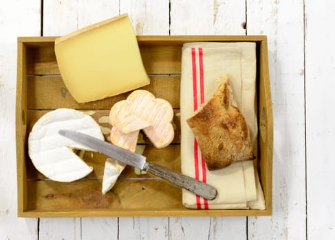 tray different french cheeses with bread and knife