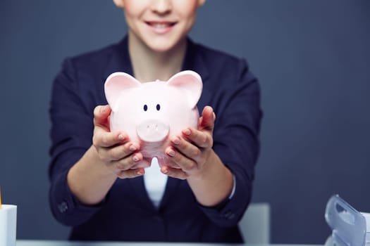 Female hands holding piggy bank