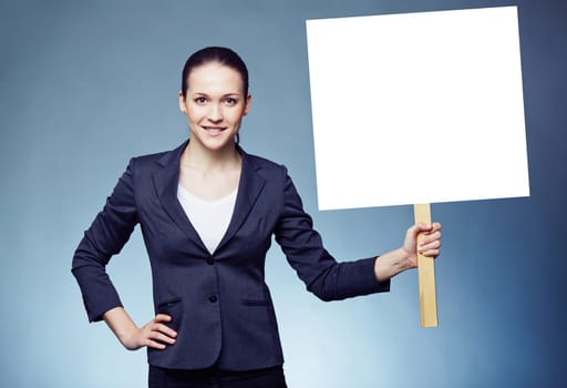 Serious businesswoman with blank paper ad