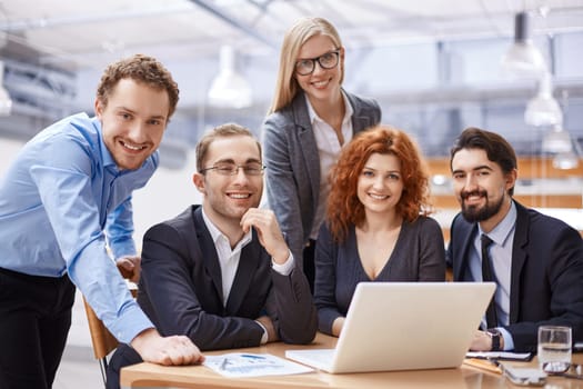 Happy business partners looking at camera with smiles