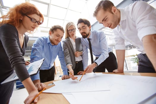 Businessman explaining project to his colleagues at meeting