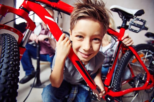 Cute boy with wrench looking at camera