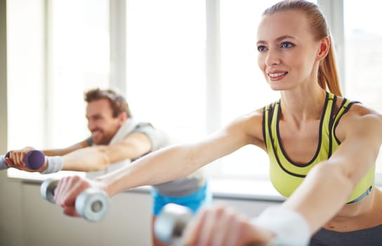 Young woman exercising in gym