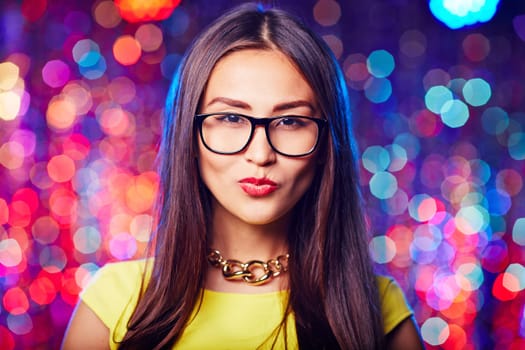 Asian brunette in eyeglasses looking at camera