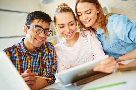 Clever teenagers using touchpad for networking