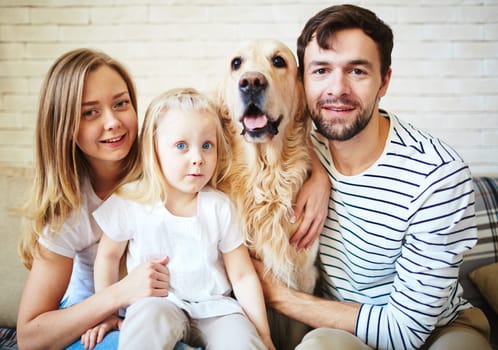 Parents, their daughter and dog spending weekend at home