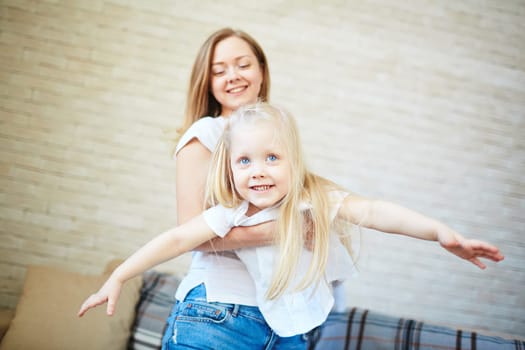 Young woman playing with her daughter