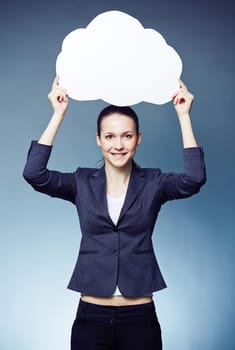 Pretty businesswoman showing blank speech bubble and looking at camera
