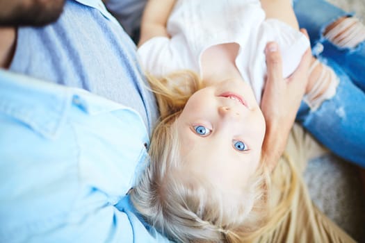 Serene girl on her father’s arms