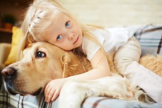 Cute child lying on fluffy pet