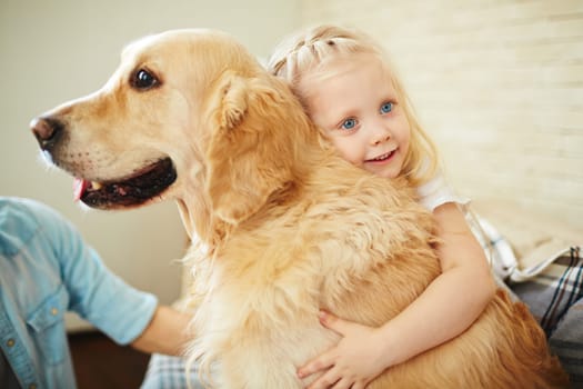 Adorable little girl embracing dog