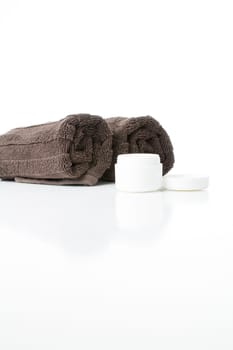 Open cream tin and towels