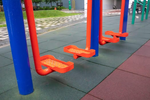 Exercise machines and fitness equipment for exercising on an open air sports ground in cloudy rainy weather without people
