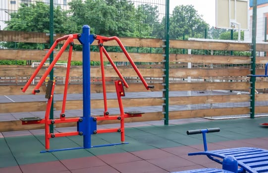 Exercise machines and fitness equipment for exercising on an open air sports ground in cloudy rainy weather without people