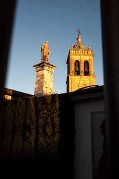 Santiago Apostle Church tower and Christ statue at sunset, Montilla, Cordoba, Andalusia, Spain