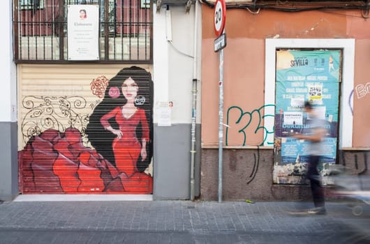 Seville, Spain - Sept 26th 2020: Man walking by narrow streets of Macarena neighborhood, Seville, Spain. Blurred motion shot