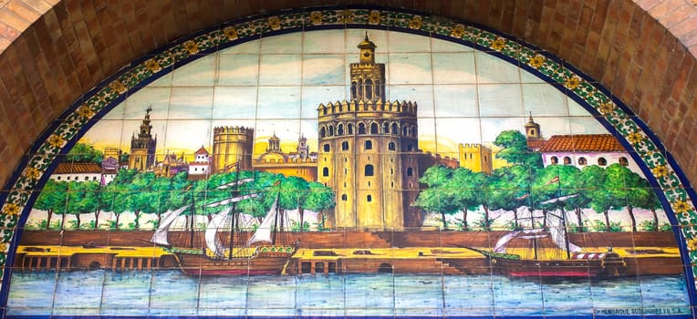 Seville, Spain - Sept 27th 2020: Guadalquivir harbour scene with sailing ships, Seville, Spain. Sevillian glazed tile panel