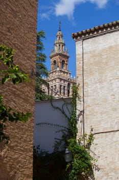 Tower La Giralda seen from downtown traditional red brick building, Seville, Spain