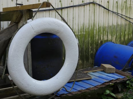 white lifebuoy swaying old pier, close-up