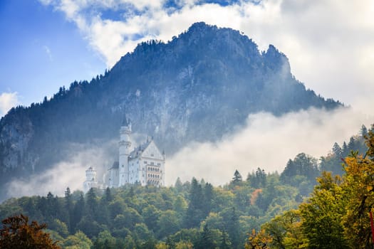 Scenic view of the Neuschwanstein Castle in morning fog