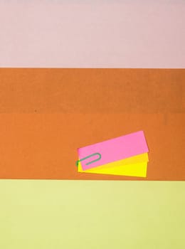 Paper clip Attachment on Kraft paper. Abstract background color art minimalist design. Vertical. Flat Lay.