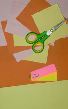 Color paper and scissors lying on table. DIY Paper Crafts cutting and making creative art background photography. Directly above. Flat lay.