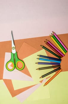Set of tools for Scrapbook Artist and Paper Crafter. Colour paper, scissors, pencils, paint, and ruler on table. DIY Paper Crafts making creative background. Flat lay.