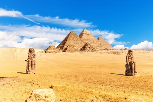 Pyramids of Egypt and The Colossi of Memnon in the desert of Giza.