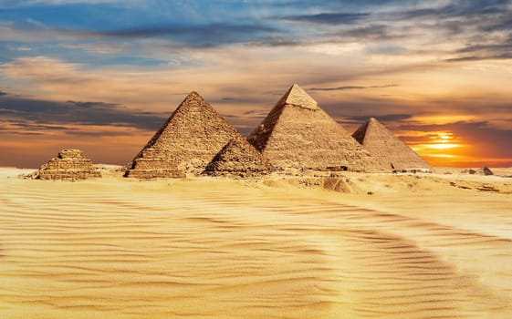 Pyramids of Egypt at sunset, famous Wonder of the World, Giza.