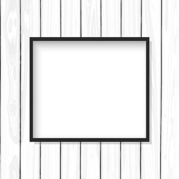 Blank picture frame on a white wooden texture