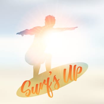 Silhouette of a surfer on a defocussed summer background with the wording Surf's Up