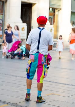 Belgrade, Serbia - JULE 15, 2021: The Street clown in a busy pedestrian street in the heart of Belgrade entertains passers-by and children