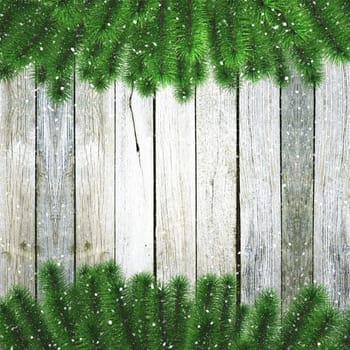 3D render of Christmas tree branches with snow on a wooden texture