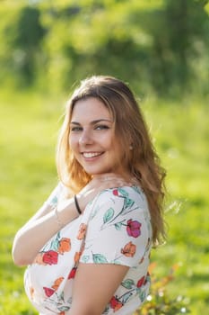 Laughing beautiful young woman posing in summer day. Vertically.