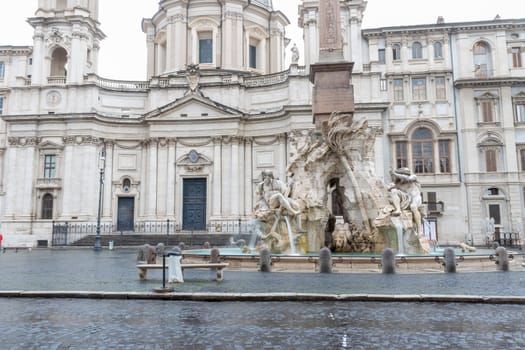 Black and white photo of the Fountain of the Four Rivers in empty Navona Square. Rome. Italy. Horizontally.