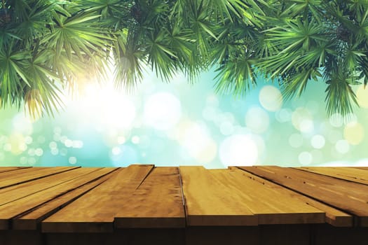 3D render of an old wooden table and palm tree leaves on a defocussed bokeh lights background