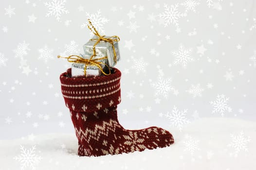 Christmas background with festive stocking full of gifts nestled in snow