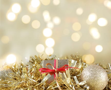 Christmas gift and decorations nestled in gold garland