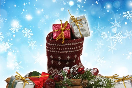 Christmas stocking full of gifts on a snowflake background