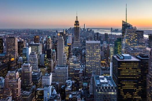 New York City. Manhattan downtown skyline with illuminated Empire State Building and skyscrapers at dusk. USA.