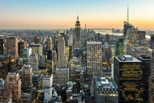 New York City. Manhattan downtown skyline with illuminated Empire State Building and skyscrapers at dusk. USA.