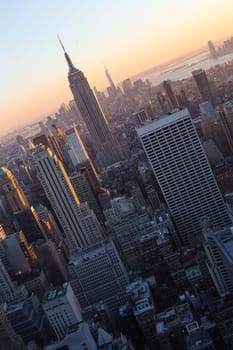 Golden sunset panoramic view of building and skyscrapers in Midtown and downtown skyline of lower Manhattan, New York City, USA.