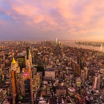 New York City skyline with Manhattan skyscrapers at dramatic vibrant after the storm sunset, USA. Rainbow can be seen in background over Brooklyn bridge.